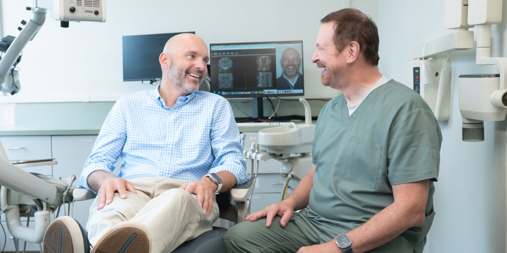 Jon and Dr. Kohler in conversation in exam room